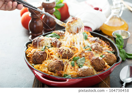 Baked meatballs with spaghetti and cheese 104730458
