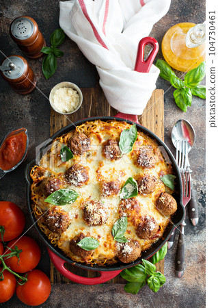 Baked meatballs with spaghetti and cheese 104730461