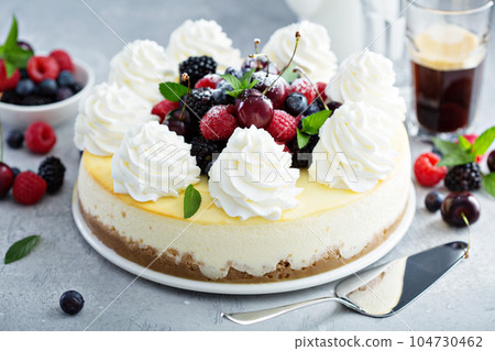 Classic New York cheesecake decorated with whipped cream Classic New York cheesecake decorated with whipped cream 104730462