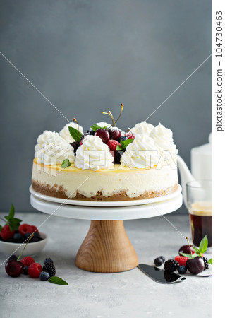 Classic New York cheesecake decorated with whipped cream 104730463