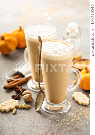 Pumpkin spice latte in tall mugs Pumpkin spice latte in tall mugs 104730540