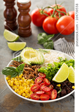 Mexican salad bowl with rice and pulled pork 104730558