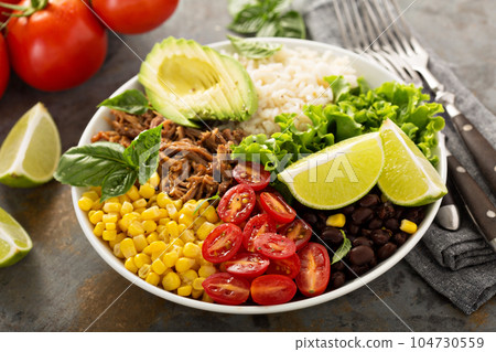 Mexican salad bowl with rice and pulled pork 104730559