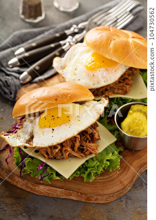 Pulled pork breakfast sandwiches with fried egg 104730562