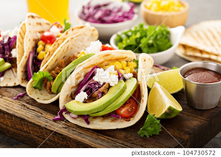 Pulled pork tacos with red cabbage and avocados 104730572