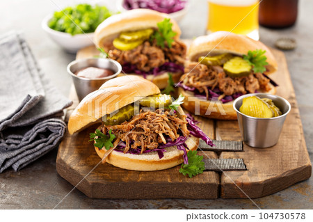 Pulled pork sandwiches with cabbage and pickles Pulled pork sandwiches with cabbage and pickles 104730578