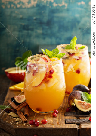 Fall sangria cocktail with apple, figs and orange Fall sangria cocktail with apple, figs and orange 104730582