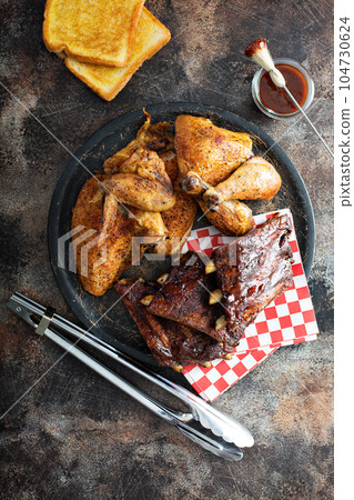 Grilled or smoked ribs and chicken Grilled or smoked ribs and chicken 104730624