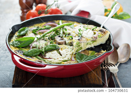 Asparagus, mushrooms and goat cheese frittata 104730631