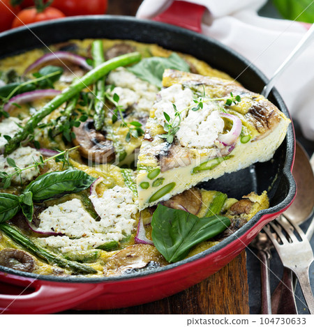 Asparagus, mushrooms and goat cheese frittata 104730633