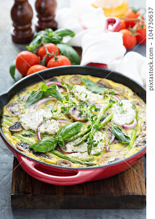 Asparagus, mushrooms and goat cheese frittata 104730637