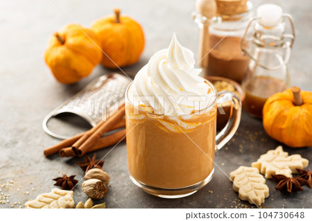 Pumpkin spice latte in a glass mug 104730648