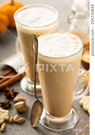 Pumpkin spice latte in tall mugs 104730649