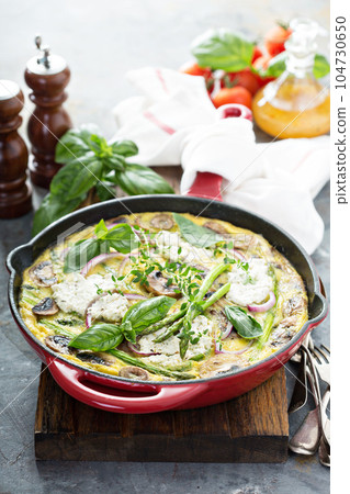 Asparagus, mushrooms and goat cheese frittata 104730650