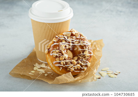 Almond and caramel glazed donut with cherry 104730685