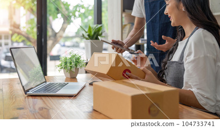 Asian Couple lover checking order and prepare parcel for customers at home, seller online concept 104733741
