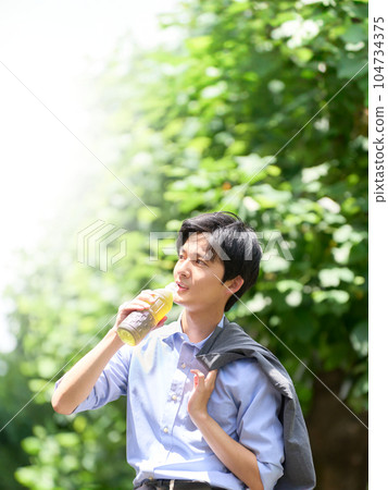 一個年輕人用塑料瓶補水 104734375