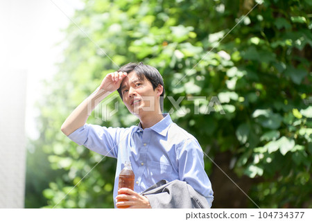 A young man frowning in the heat A young man frowning in the heat 104734377