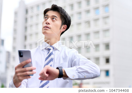 A business person in a white shirt who confirms the time and place 104734408