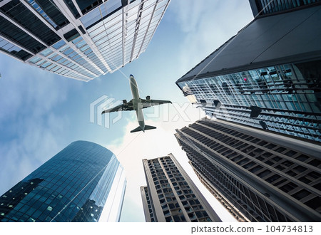 a skyscrapers and airplane in sky in city 1 a skyscrapers and airplane in sky in city 1 104734813
