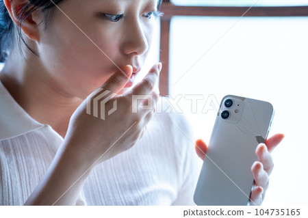 Young woman shocked by breaking her smartphone 104735165