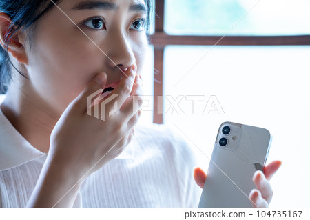 Young woman shocked by breaking her smartphone 104735167