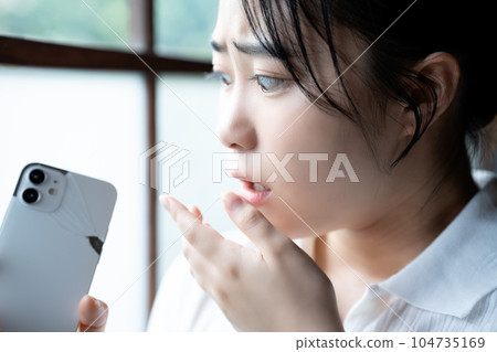 Young woman shocked by breaking her smartphone Young woman shocked by breaking her smartphone 104735169