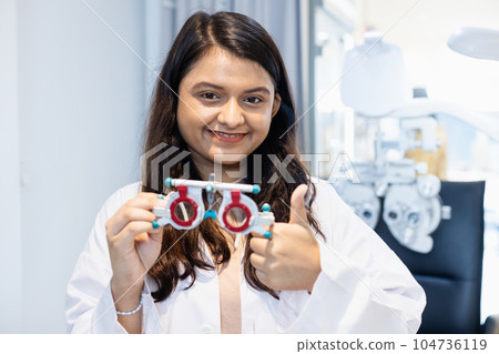 female doctor optometrist showing messbrille eye test glasses. Eyesight modern. female doctor optometrist showing messbrille eye test glasses. Eyesight modern. 104736119