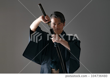 一個拿著日本刀的男人 黑色背景 104736480