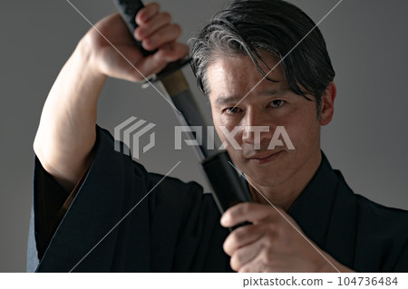 A man with a Japanese sword Black background 104736484