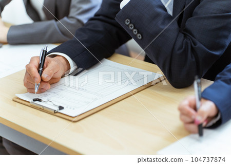 Interviewer examining while looking at resume 104737874