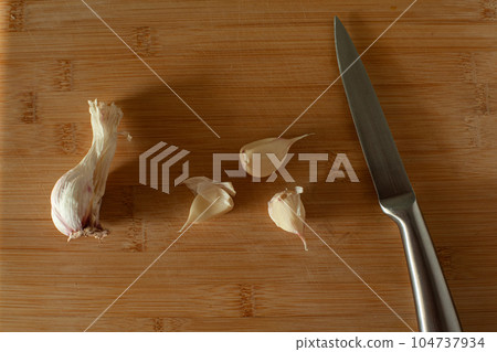 Garlic on wooden background Garlic on wooden background 104737934