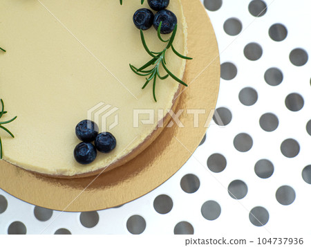 cheesecake decorated with blueberry berries and sprigs of rosemary cheesecake decorated with blueberry berries and sprigs of rosemary 104737936