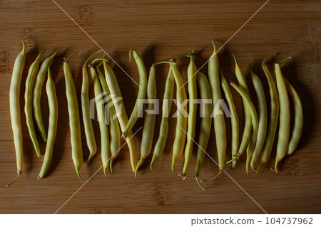 Yellow and green kidney beans on dark background 104737962