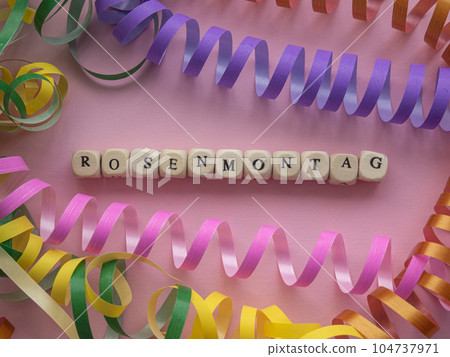 Rosenmontag in wooden cubes on pink background Rosenmontag in wooden cubes on pink background 104737971