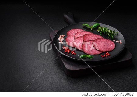 Delicious smoked salami sausage with salt, pepper, spices and herbs Delicious smoked salami sausage with salt, pepper, spices and herbs 104739098