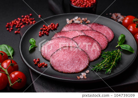 Delicious smoked salami sausage with salt, pepper, spices and herbs 104739109