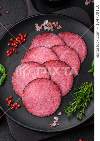 Delicious smoked salami sausage with salt, pepper, spices and herbs 104739110