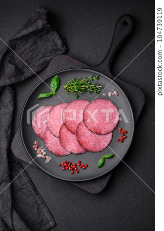 Delicious smoked salami sausage with salt, pepper, spices and herbs Delicious smoked salami sausage with salt, pepper, spices and herbs 104739119