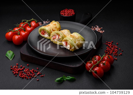 Delicious healthy vegetarian vegetable roll of zucchini, tomatoes, peppers and sauce Delicious healthy vegetarian vegetable roll of zucchini, tomatoes, peppers and sauce 104739129