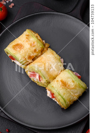 Delicious healthy vegetarian vegetable roll of zucchini, tomatoes, peppers and sauce 104739133