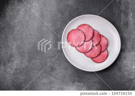 Delicious smoked salami sausage with salt, pepper, spices and herbs 104739150