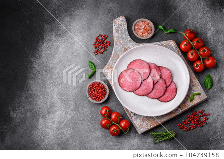 Delicious smoked salami sausage with salt, pepper, spices and herbs 104739158