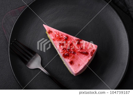 Delicious sweet dessert cheesecake with raspberry and pistachio flavor Delicious sweet dessert cheesecake with raspberry and pistachio flavor 104739187