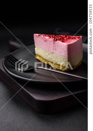 Delicious sweet dessert cheesecake with raspberry and pistachio flavor 104739533