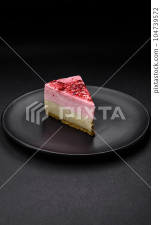 Delicious sweet dessert cheesecake with raspberry and pistachio flavor 104739572