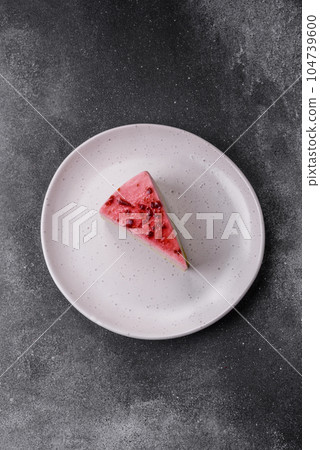 Delicious sweet dessert cheesecake with raspberry and pistachio flavor 104739600