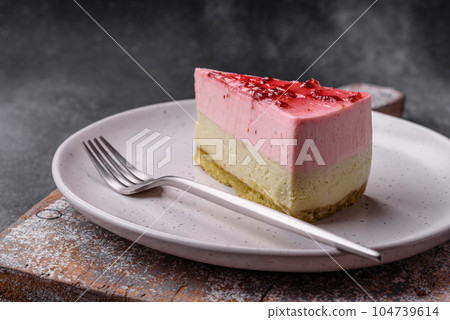 Delicious sweet dessert cheesecake with raspberry and pistachio flavor 104739614
