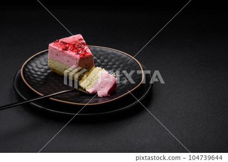 Delicious sweet dessert cheesecake with raspberry and pistachio flavor Delicious sweet dessert cheesecake with raspberry and pistachio flavor 104739644