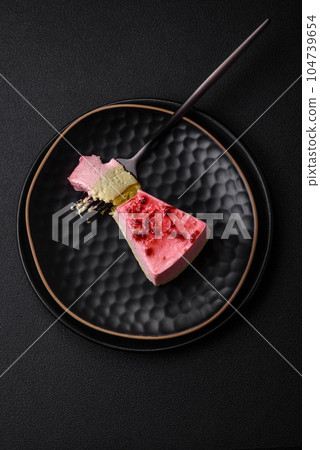 Delicious sweet dessert cheesecake with raspberry and pistachio flavor Delicious sweet dessert cheesecake with raspberry and pistachio flavor 104739654